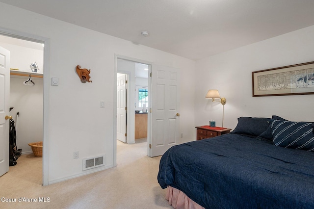 bedroom featuring light carpet and baseboards