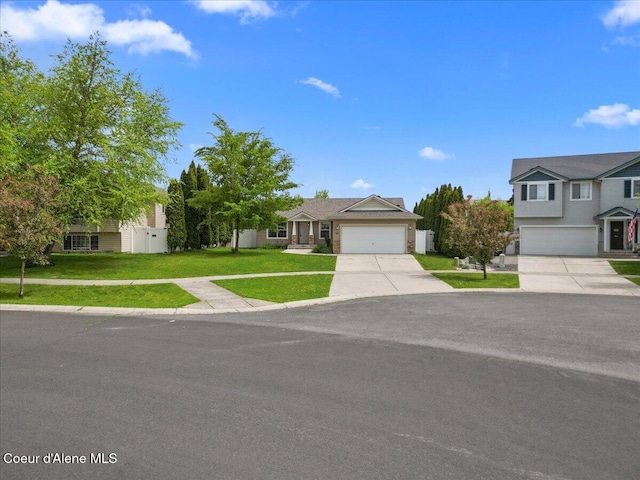 3459 E White Sands Ln, Post Falls, ID 83854 - view of front of house with concrete driveway, a front lawn, and an attached garage