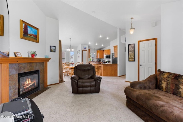 3459 E White Sands Ln, Post Falls, ID 83854 - living room featuring light carpet, a fireplace with flush hearth, baseboards, high vaulted ceiling, and recessed lighting