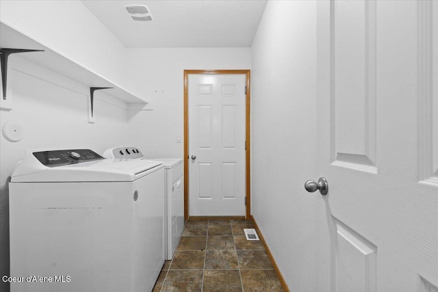 3459 E White Sands Ln, Post Falls, ID 83854 - laundry room with washer and dryer, dark stone finish flooring, and baseboards