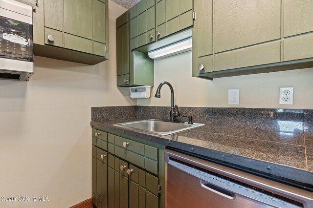 495 NW Psge # 103, Sandpoint, ID 83864 - kitchen with stainless steel appliances, green cabinetry, a sink, and tile counters