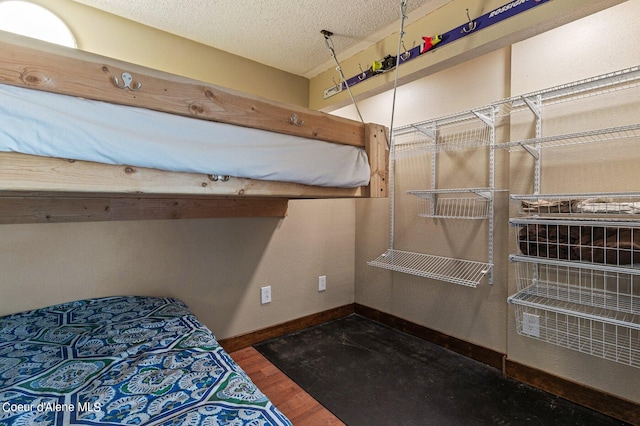 495 NW Psge # 103, Sandpoint, ID 83864 - bedroom with baseboards, wood finished floors, and a textured ceiling
