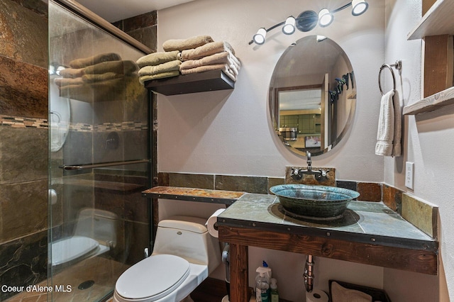 495 NW Psge # 103, Sandpoint, ID 83864 - bathroom with a sink, a stall shower, and toilet