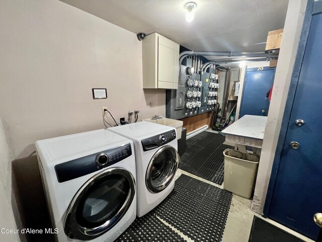 495 NW Psge # 103, Sandpoint, ID 83864 - washroom featuring cabinet space, washer and clothes dryer, and tile patterned floors