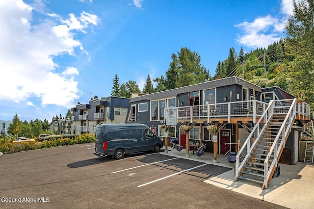 495 NW Psge # 103, Sandpoint, ID 83864 - view of front of property featuring a deck, uncovered parking, and stairs