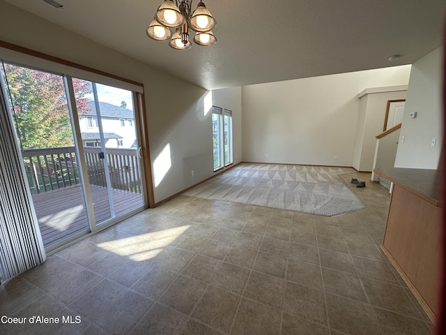 1374 N Kaleigh Ct, Coeur Dalene, ID 83814 - tiled spare room featuring a chandelier and baseboards
