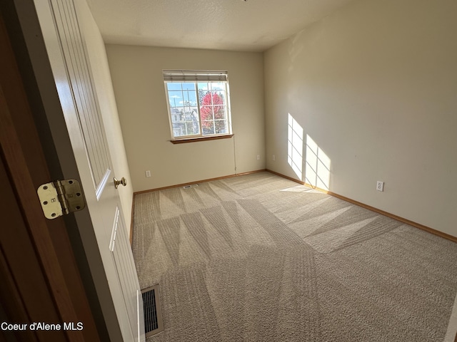 1374 N Kaleigh Ct, Coeur Dalene, ID 83814 - spare room featuring light carpet and baseboards