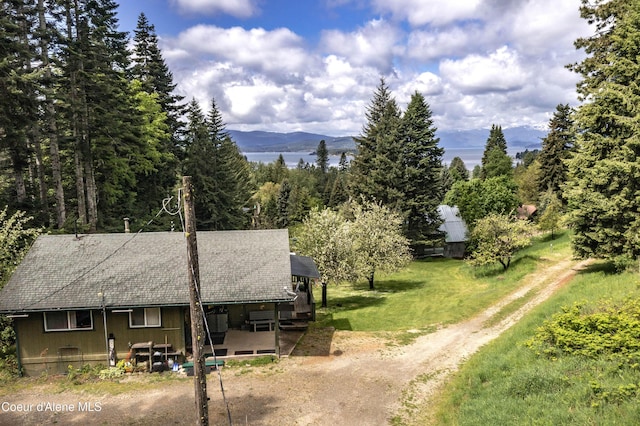 view from above of property with mountains and a forest