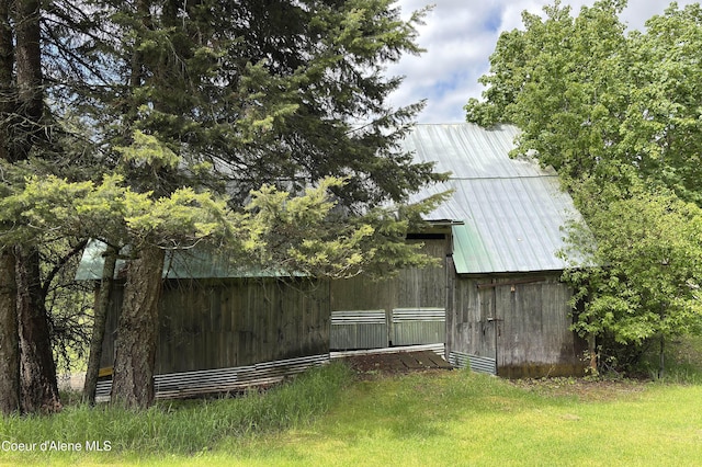 view of green lawn with a barn and an outdoor structure