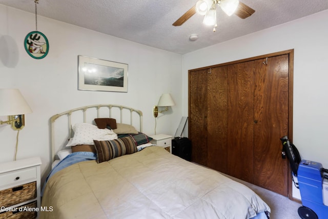 bedroom featuring a closet, a textured ceiling, carpet, and a ceiling fan