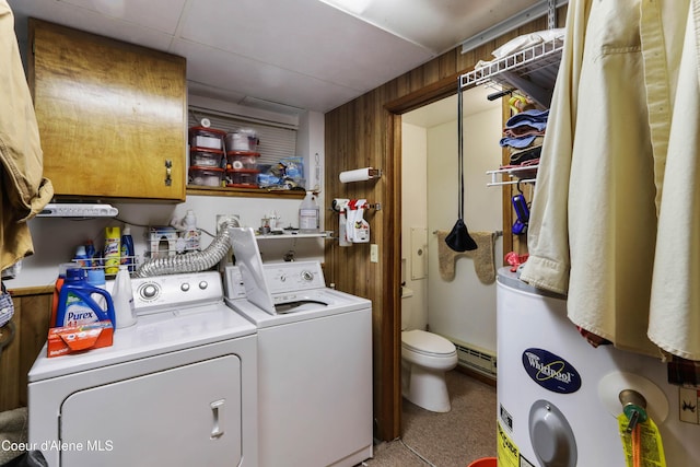 laundry room with independent washer and dryer, water heater, cabinet space, and wood walls