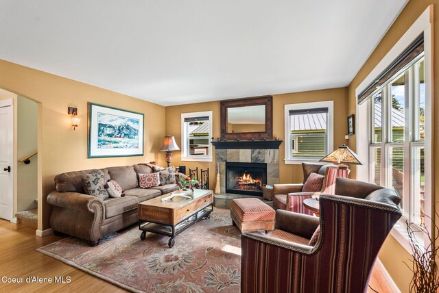 619 N Florence Ave, Sandpoint, ID 83864 - living room with a tile fireplace, wood finished floors, and baseboards