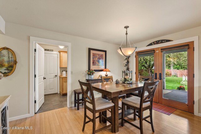 619 N Florence Ave, Sandpoint, ID 83864 - dining room featuring light wood finished floors, french doors, and baseboards