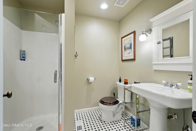 619 N Florence Ave, Sandpoint, ID 83864 - full bathroom with a shower stall, baseboards, toilet, recessed lighting, and tile patterned floors