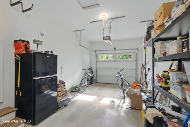 619 N Florence Ave, Sandpoint, ID 83864 - garage with a garage door opener and freestanding refrigerator
