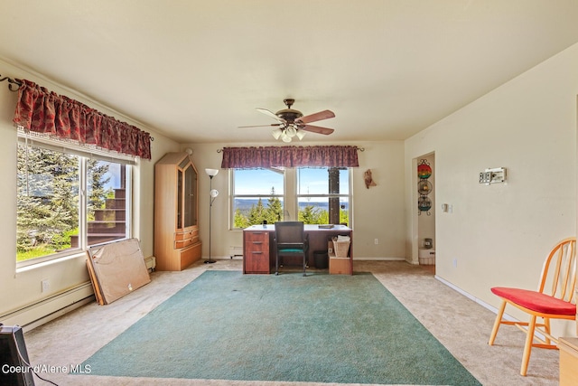 home office with healthy amount of natural light, a ceiling fan, light carpet, and baseboard heating