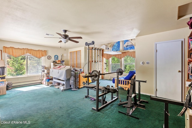 workout area featuring baseboard heating, carpet floors, and ceiling fan