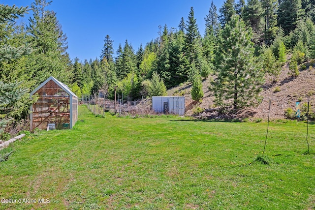 view of grassy yard with an exterior structure and an outdoor structure
