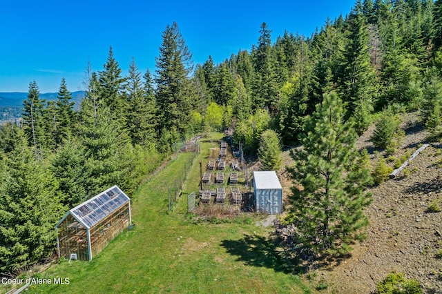 aerial view of property and surrounding area with a forest