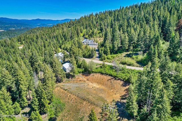 bird's eye view of a heavily wooded area and mountains