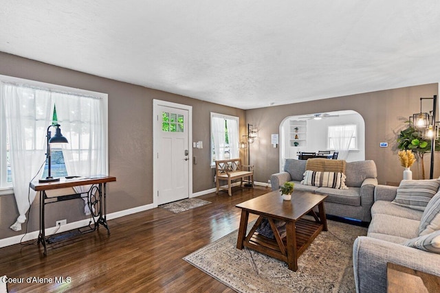 908 E Coeur D Alene Ave, Coeur Dalene, ID 83814 - living area with arched walkways, wood finished floors, baseboards, and a ceiling fan