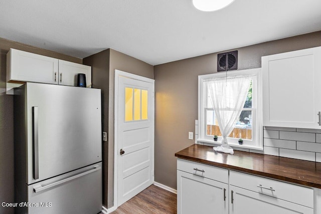 908 E Coeur D Alene Ave, Coeur Dalene, ID 83814 - kitchen featuring freestanding refrigerator, wooden counters, wood finished floors, and white cabinets