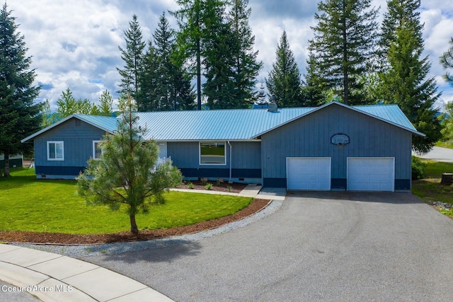 42 Bodie Ln, Priest River, ID 83856 - single story home featuring an attached garage, metal roof, asphalt driveway, and a front yard