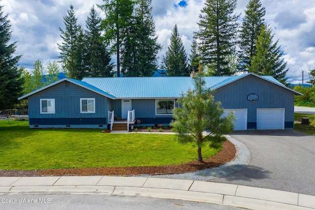 42 Bodie Ln, Priest River, ID 83856 - ranch-style home with driveway, metal roof, a front yard, and an attached garage