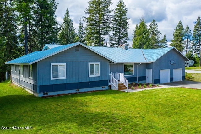 42 Bodie Ln, Priest River, ID 83856 - view of front facade with a garage, metal roof, asphalt driveway, and a front yard