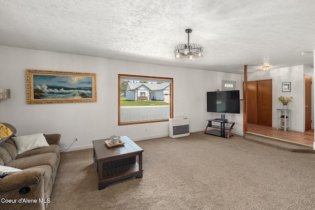 42 Bodie Ln, Priest River, ID 83856 - carpeted living room with a chandelier, a textured ceiling, baseboards, and heating unit