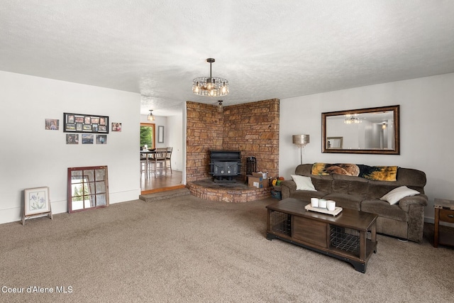 42 Bodie Ln, Priest River, ID 83856 - living area with a wood stove, carpet floors, a chandelier, and a textured ceiling