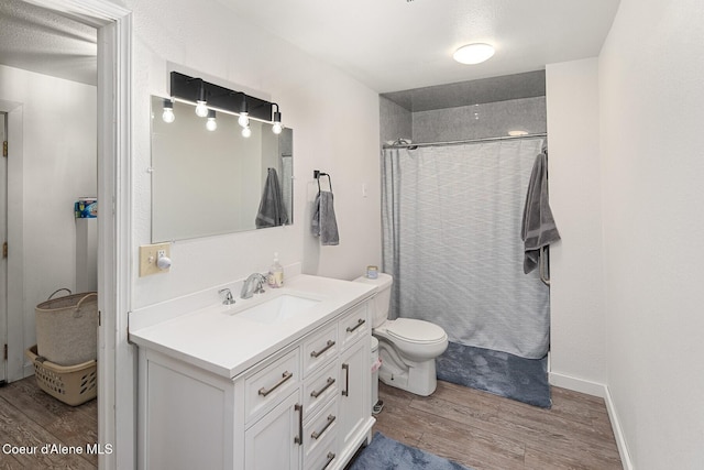 42 Bodie Ln, Priest River, ID 83856 - full bath with wood finished floors, vanity, a shower with shower curtain, and toilet