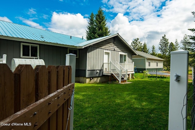 42 Bodie Ln, Priest River, ID 83856 - view of home's exterior featuring board and batten siding, a yard, and metal roof