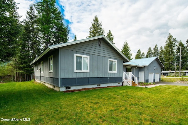 42 Bodie Ln, Priest River, ID 83856 - view of front facade featuring board and batten siding, an attached garage, asphalt driveway, and a front yard
