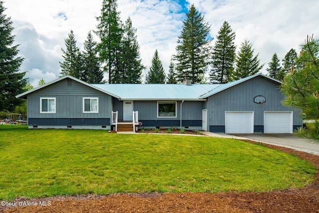 42 Bodie Ln, Priest River, ID 83856 - ranch-style home with metal roof, a garage, a front yard, and concrete driveway