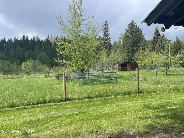 84 Highland Flats Rd, Naples, ID 83847 - view of yard featuring an outdoor structure, a forest view, and a rural view