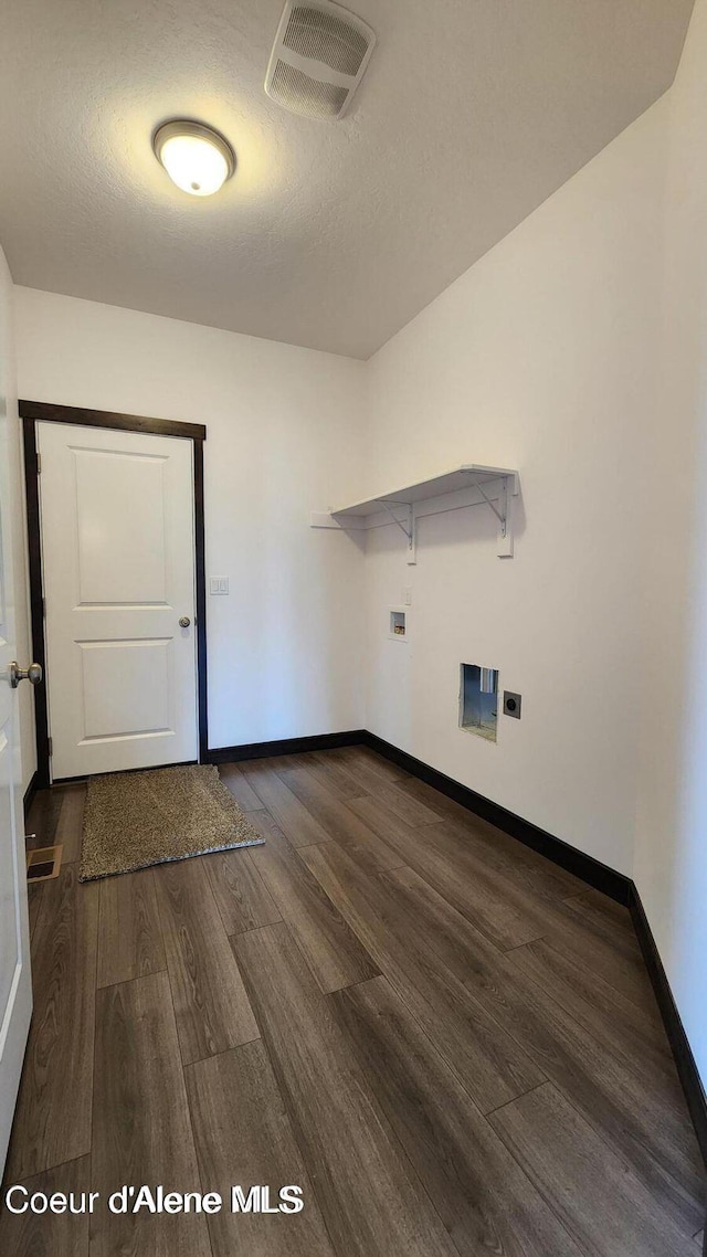 2941 N Wrenley Ln, Post Falls, ID 83854 - laundry room with wood finished floors, baseboards, washer hookup, a textured ceiling, and electric dryer hookup