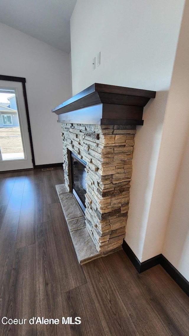 2941 N Wrenley Ln, Post Falls, ID 83854 - unfurnished living room with wood finished floors, baseboards, and a stone fireplace