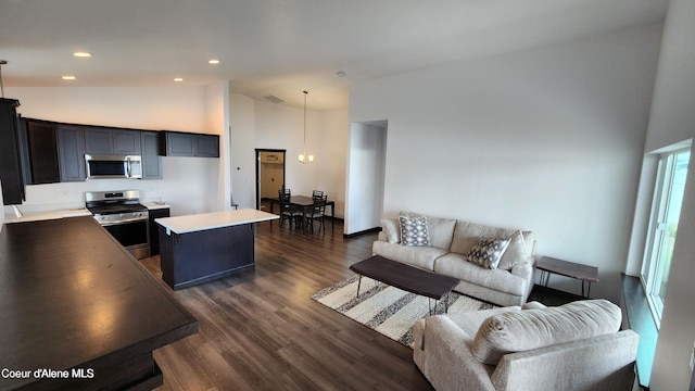 2941 N Wrenley Ln, Post Falls, ID 83854 - living area with high vaulted ceiling, a chandelier, dark wood finished floors, and recessed lighting