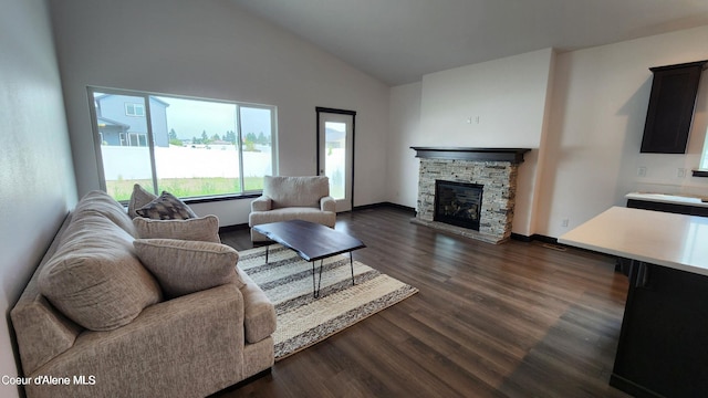 2941 N Wrenley Ln, Post Falls, ID 83854 - living room featuring dark wood-style flooring, a stone fireplace, high vaulted ceiling, and baseboards