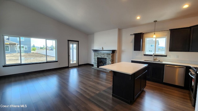 2941 N Wrenley Ln, Post Falls, ID 83854 - kitchen featuring stainless steel dishwasher, a sink, open floor plan, light countertops, and lofted ceiling