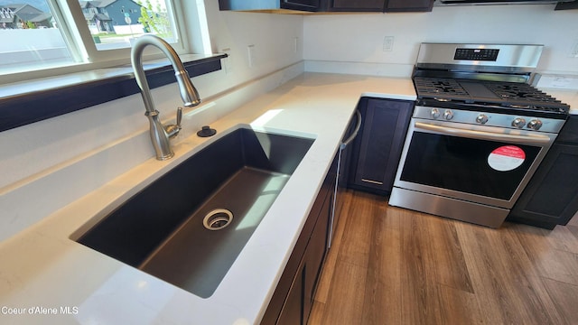 2941 N Wrenley Ln, Post Falls, ID 83854 - kitchen featuring gas range, a sink, light countertops, and wood finished floors