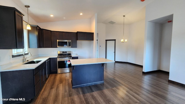 2941 N Wrenley Ln, Post Falls, ID 83854 - kitchen with a sink, appliances with stainless steel finishes, a center island, light countertops, and dark wood finished floors