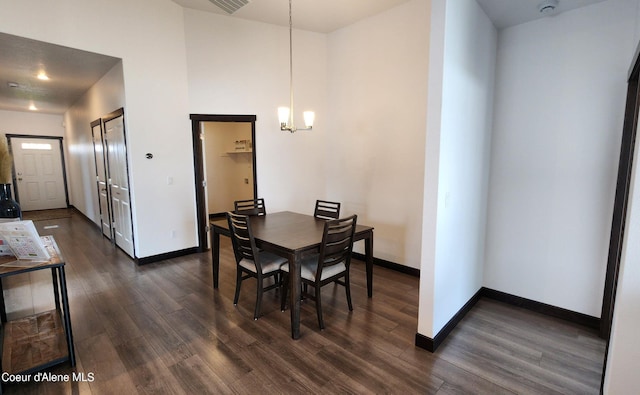 2941 N Wrenley Ln, Post Falls, ID 83854 - dining area with dark wood-type flooring, baseboards, and a chandelier