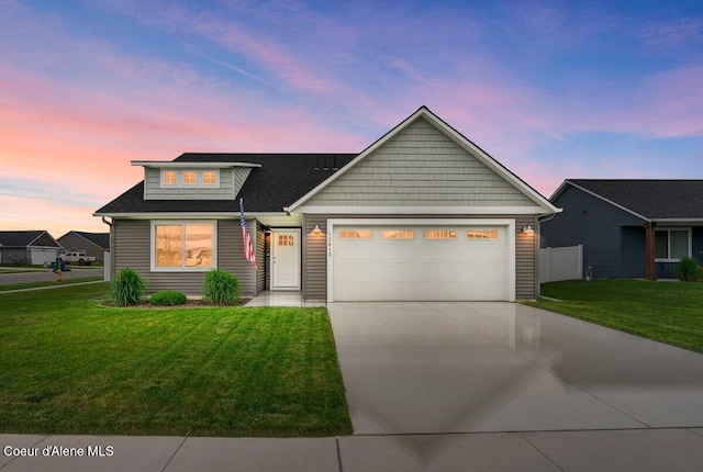 12613 N Lattner St, Rathdrum, ID 83858 - view of front of house featuring driveway, an attached garage, a yard, and a shingled roof