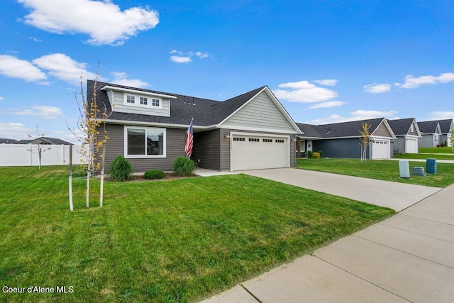 12613 N Lattner St, Rathdrum, ID 83858 - view of front of home featuring a garage, driveway, and a shingled roof