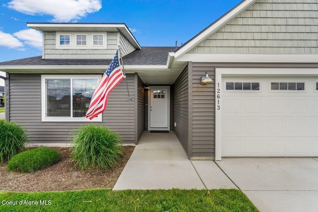 12613 N Lattner St, Rathdrum, ID 83858 - view of front of property featuring a garage and a shingled roof