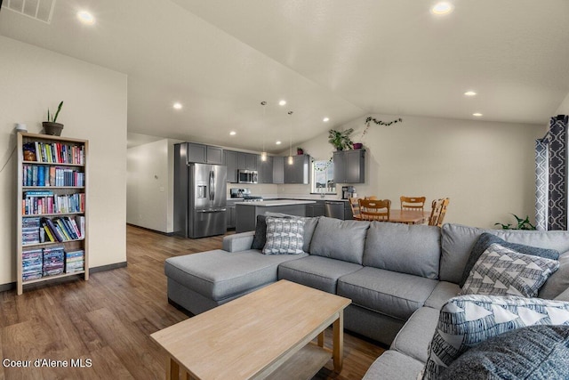 12613 N Lattner St, Rathdrum, ID 83858 - living area featuring dark wood-type flooring, lofted ceiling, recessed lighting, and baseboards