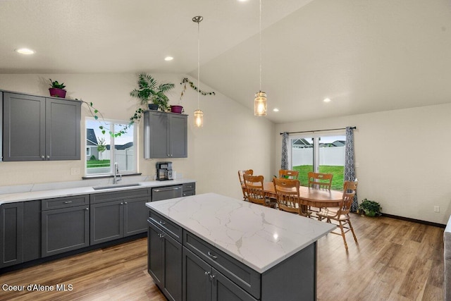 12613 N Lattner St, Rathdrum, ID 83858 - kitchen with a sink, stainless steel dishwasher, plenty of natural light, lofted ceiling, and gray cabinetry