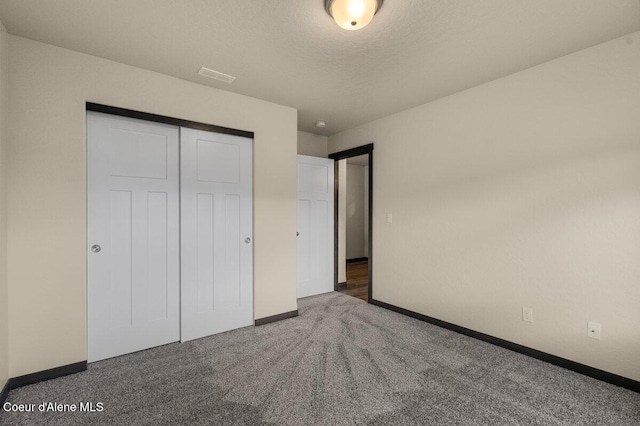 12613 N Lattner St, Rathdrum, ID 83858 - unfurnished bedroom with baseboards, carpet flooring, a closet, and a textured ceiling